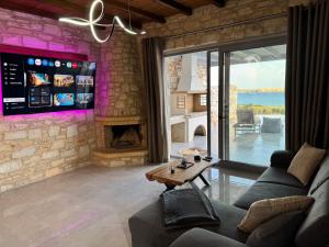 a living room with a couch and a fireplace at Drios Hillhouse II in Drios