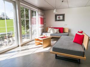 a bedroom with a bed and a couch and a table at Ferienhof Rummel Allgäu - verschiedene Unterkünfte für bis zu 6 Personen - Sauna, Spielplatz, Lagerfeuer & Frühstücksservice - ideal für Familien- und Aktivurlaub in Argenbühl