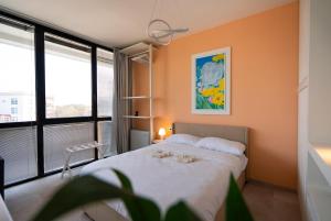 a bedroom with a bed with two stuffed animals on it at Attico Belvedere Randi in Ravenna