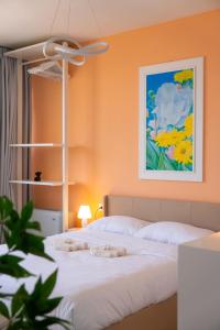 a bedroom with a bed with a painting on the wall at Attico Belvedere Randi in Ravenna