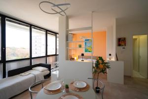 a bedroom with a bed and a table and chairs at Attico Belvedere Randi in Ravenna