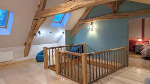 a wooden staircase in a room with wooden beams at La Ferme du Château in Beire-le-Châtel
