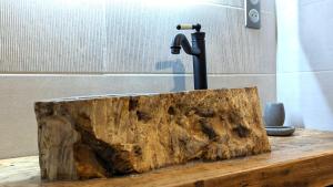 a bathtub made out of a piece of wood at La Ferme du Château in Beire-le-Châtel +27 photos