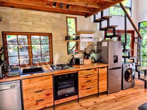 a kitchen with a stove and a refrigerator at ZenCapeTown Forest Retreat in Cape Town +33 photos