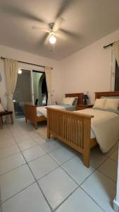 a bedroom with two beds and a ceiling fan at Luxury 3Bedroom Villa with Pool, Garden & Sunset in Tala +28 photos