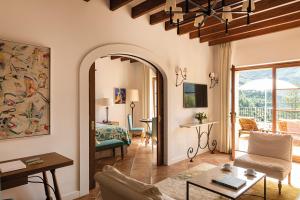 a living room with a couch and a table at La Residencia, A Belmond Hotel, Mallorca in Deia