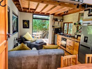 a kitchen and living room in a tiny house at ZenCapeTown Forest Retreat in Cape Town