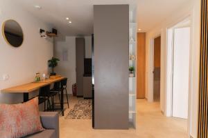 a living room and kitchen with a table and chairs at Opus Boutique Apartment in Alexandroupoli