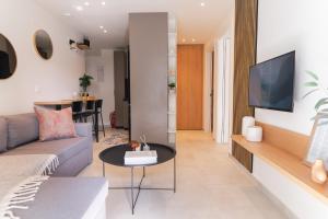 a living room with a couch and a table at Opus Boutique Apartment in Alexandroupoli