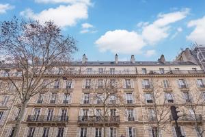 a large building with trees in front of it at Charming Studio Arc de Triomphe Monceau in Paris