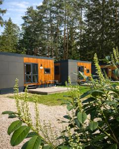 two small modular homes in a yard with trees at Waldcamping Brombach in Pleinfeld