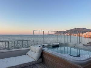 a hot tub on a balcony overlooking the ocean at Cielomare Residence Diffuso in Trapani