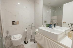 a white bathroom with a toilet and a sink at Luxury Beach House by Hosty in Canidelo +61 photos