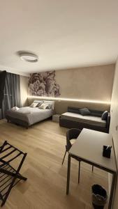 a bedroom with two beds and a table and a couch at Affittacamere Nonna Maria in Foggia