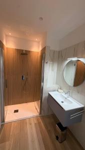 a bathroom with a shower and a white sink at Affittacamere Nonna Maria in Foggia