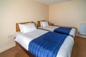 two beds in a hotel room with at Carrington House Hotel in Bournemouth