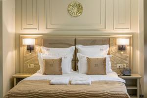 a bedroom with a large bed with white pillows at Davo Hotel in Târgu Neamț