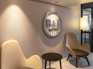 a waiting room with two chairs and a mirror at B&B HOTEL Gießen-Linden in Gießen