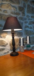 a lamp on top of a table with two lamps at Chambre double chez Emilienne in Téterchen