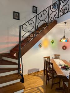 a dining room with a staircase and a table with chairs at Arcangelo SUITE in Assisi