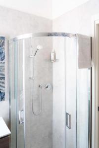 a shower with a glass door in a bathroom at Aparthotel Manolita in Rimini +39 photos