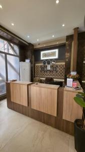 a kitchen with wooden counter tops in a room at Al-Mahasen Hotel in An Najaf