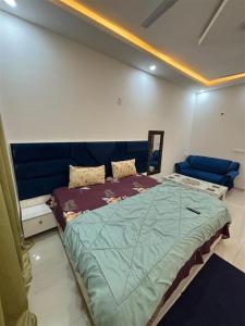 a bedroom with a large bed in a room at istudio in Ghaziabad