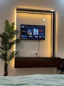 a television on a wall in a bedroom at istudio in Ghaziabad
