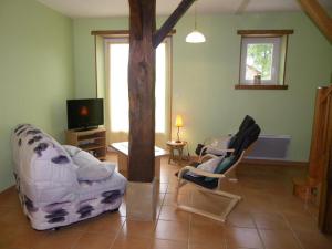 a living room with two chairs and a tree at Le mouly/petit gite in Miossens-Lanusse
