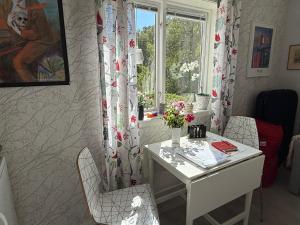 a home office with a desk and a window at Grottstugan in Ljungskile +16 photos
