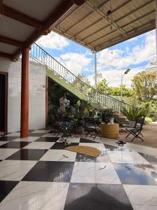 a patio with a staircase and a checkered floor at Líu homestay in Klong A