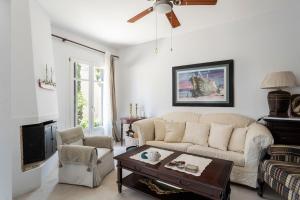a living room with a couch and a coffee table at Eagle House Spetses 4 bedrooms in Spetses