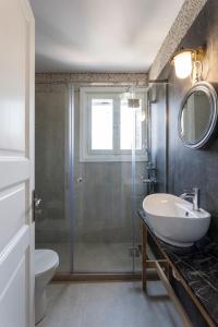 a bathroom with a shower and a sink and a toilet at Eagle House Spetses 4 bedrooms in Spetses +20 photos