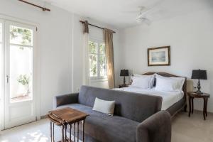 a living room with a bed and a couch at Eagle House Spetses 4 bedrooms in Spetses