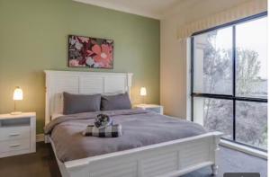 a bedroom with a large bed and a large window at Home in Highton in Highton
