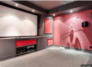 a living room with a flat screen tv and a large screen at Home in Highton in Highton