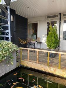 a patio with a koi pond on a house at Appartement met jacuzzi in Huizen in Huizen
