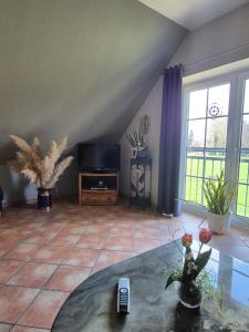 a living room with a tv and a table at Ferienhof Michaelis in Bruchhausen-Vilsen