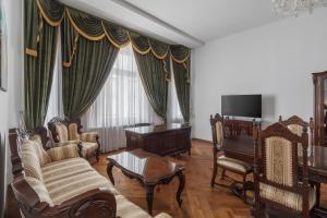 a living room with furniture and a flat screen tv at Casa Doseanu , Stern Palace Historic Residence in Oradea