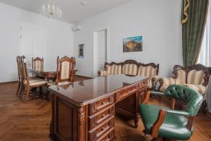 an office with a wooden desk and chairs at Casa Doseanu , Stern Palace Historic Residence in Oradea