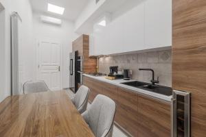 a kitchen with a wooden table and a wooden counter top at Casa Doseanu , Stern Palace Historic Residence in Oradea