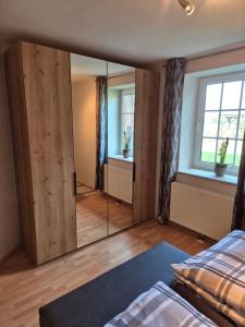 a bedroom with a large mirror in a room at Ferienhof Michaelis in Bruchhausen-Vilsen