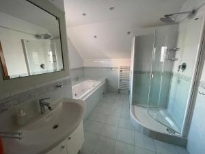 a bathroom with a tub and a sink and a shower at Vinný sklep Tesařík in Prušánky