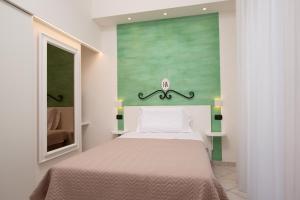 a bedroom with a bed and a painting on the wall at Ancora Hotel & Residence in Cattolica +23 photos