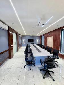 a large conference room with a long table and chairs at Hotel Starway in Hisār