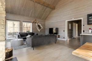 a living room with a couch and a tv at Röningen 24 - Bruksvallarna in Bruksvallarna