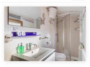 a white bathroom with a sink and a shower at Appartamento la Speranza in Grosseto +29 photos