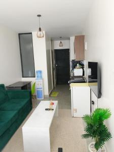 a living room with a green couch and a table at Home Away in Ongata Rongai 