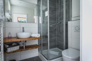 a bathroom with a glass shower and a toilet at Gästehaus Alpenkranz in Garmisch-Partenkirchen +42 photos