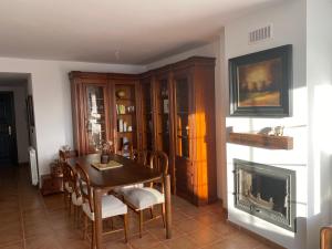 ein Esszimmer mit Tisch und Kamin in der Unterkunft Mendia in Jaca
